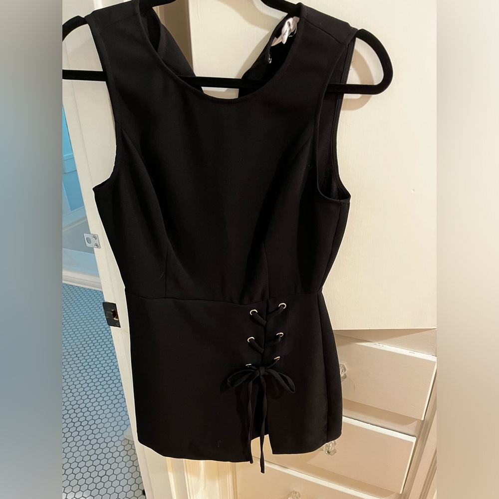 BCBGENERATION a black lace up detail romper worn twice